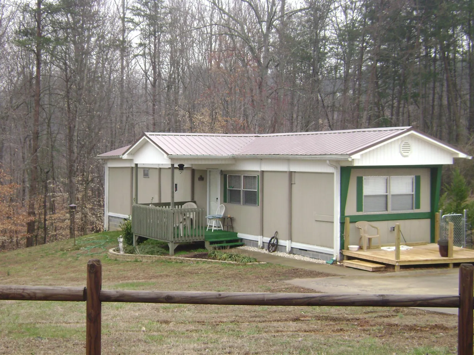 Mauve metal roof on a manufactured home with a new front deck in Calhoun City